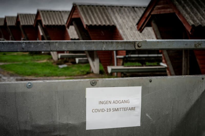 A sign in Danish warns "No access. Risk of infecting COVID-19" at a mink farm in Hjoerring in North Jutland