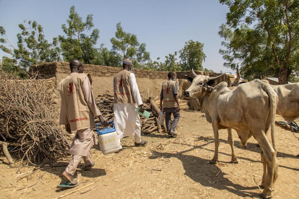 A mobile immunisation team walking through a remote community looking for children to vaccinate (Yagazie Emezi/Save The Children)