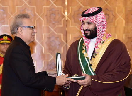 Pakistani President Arif Alvi (L) conferring country's highest civil award Nishan-e-Pakistan to Saudi Arabia's Crown Prince Mohammed bin Salman at the President House in Islamabad, Pakistan February 18, 2019. Press Information Department (PID)/Handout via REUTERS