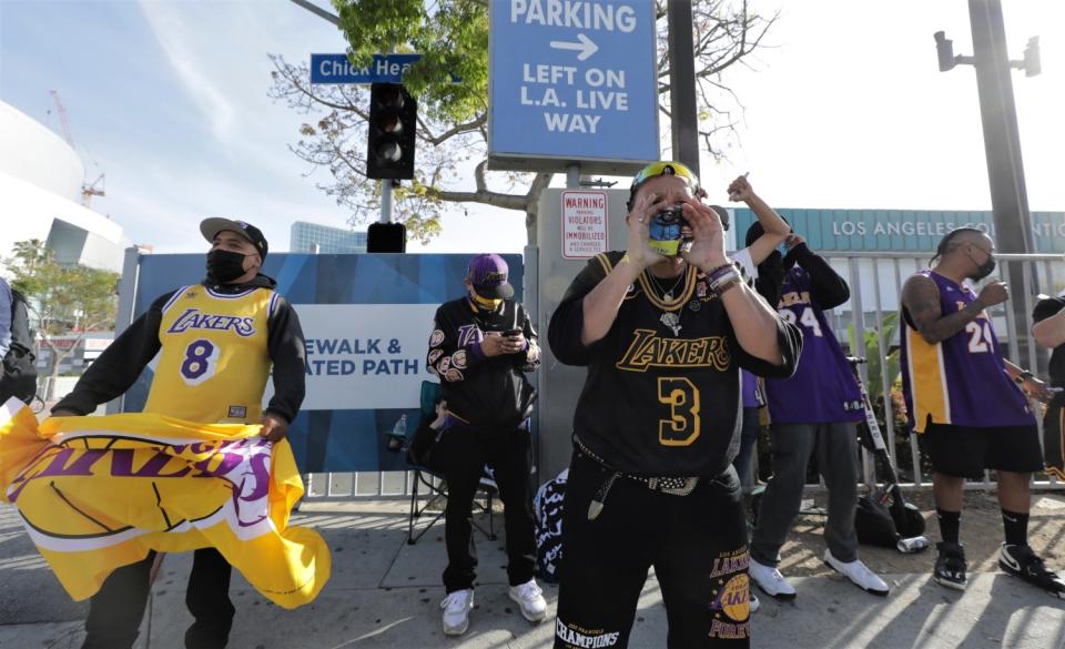 Lakers fan Desiree Engle leads a chant of "Boston sucks" toward some people wearing Celtics jerseys on Thursday.