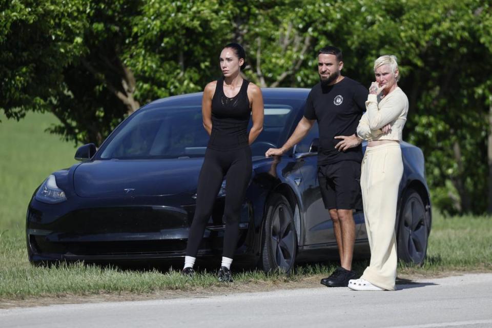 People who identified themselves as family members watch Miami-Dade Police and Broward Sherriff’s Office investigate a body in Homestead, Florida on Tuesday, June 18, 2024. A BSO deputy died by suicide Tuesday morning and his body was found in Homestead.