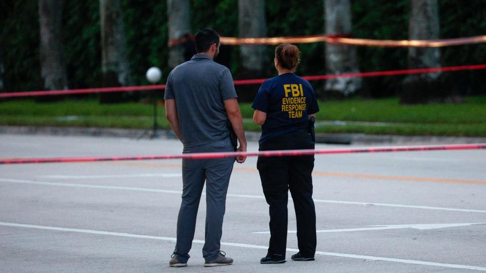 Officials walk near the scene of an attempted assassination of Donald Trump