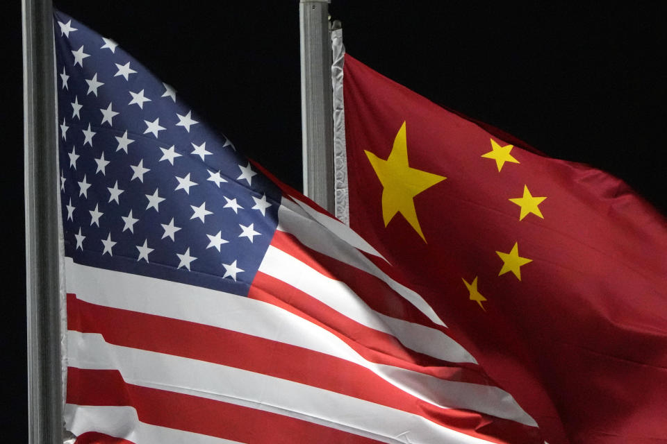 FILE - The American and Chinese flags wave at Genting Snow Park ahead of the 2022 Winter Olympics, Feb. 2, 2022, in Zhangjiakou, China. As President Joe Biden and Chinese leader Xi Jinping prepare to meet at the upcoming Asia-Pacific Economic Cooperation summit in San Francisco, basic information has remained guarded. That could ratchet up the pressure on how each side negotiates, down to the smallest detail. (AP Photo/Kiichiro Sato, File)