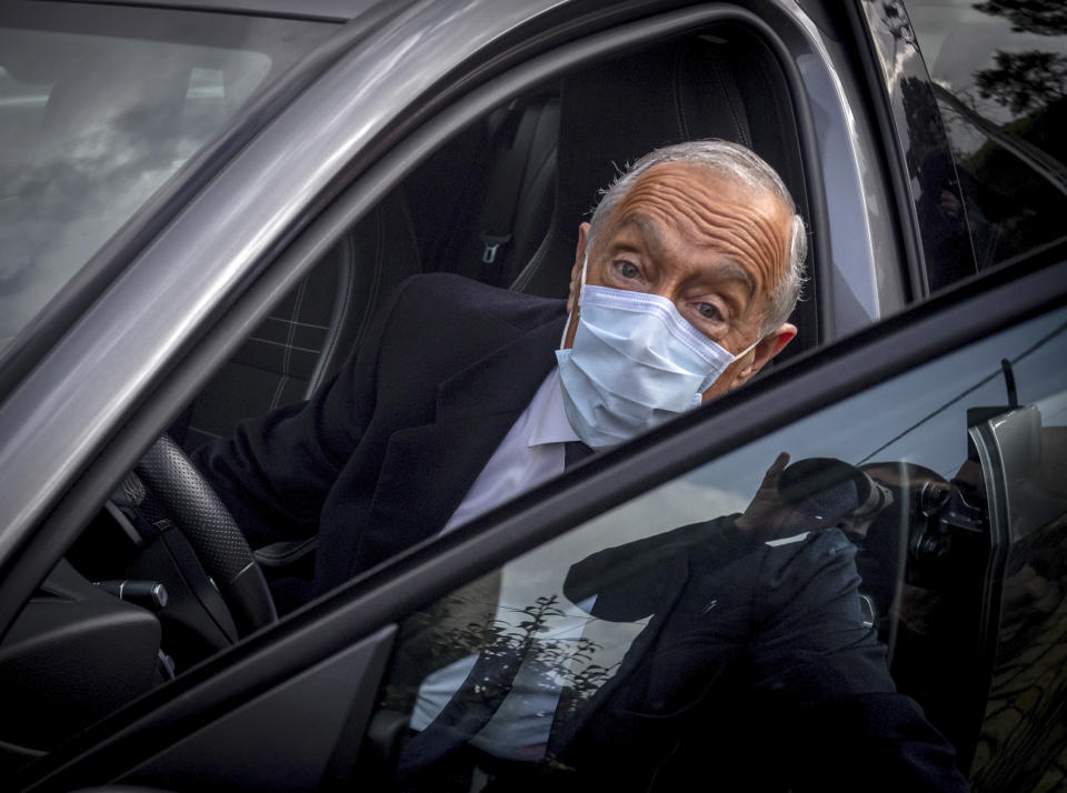 Portuguese President, and candidate for reelection, Marcelo Rebelo de Sousa gets in his car after voting at a polling station in Celorico de Basto, northern Portugal, Sunday, Jan. 24, 2021. Portugal holds a presidential election Sunday, choosing a head of state to serve a five-year term. (AP Photo/Luis Vieira)