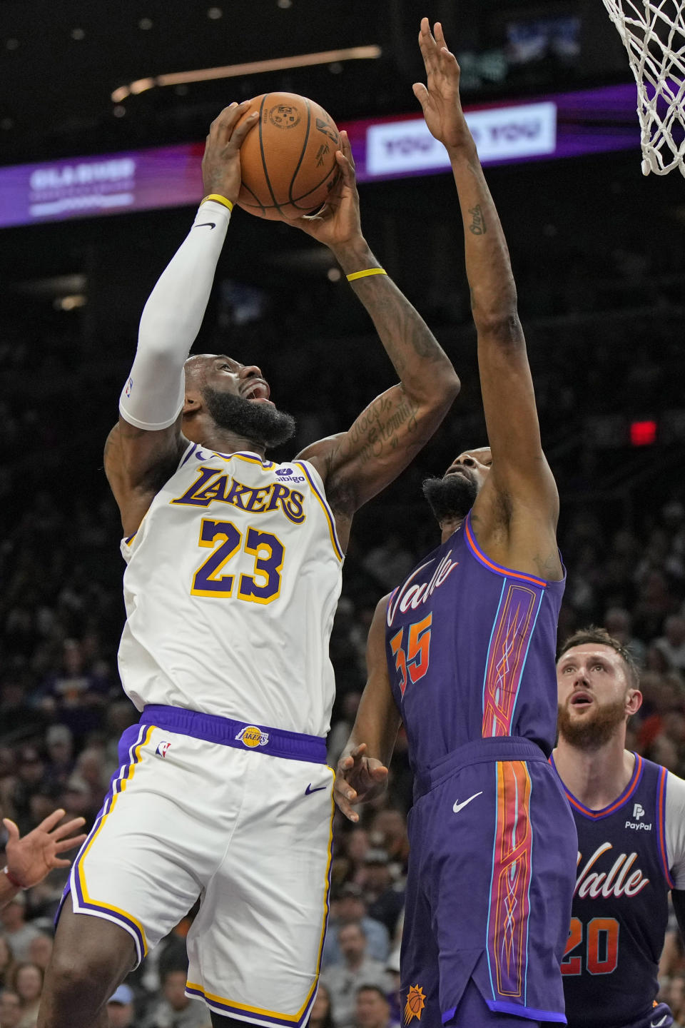 Los Angeles Lakers forward LeBron James (23) shoots over Phoenix Suns forward Kevin Durant (35) during the first half of an NBA basketball game, Sunday, Feb. 25, 2024, in Phoenix. (AP Photo/Rick Scuteri)