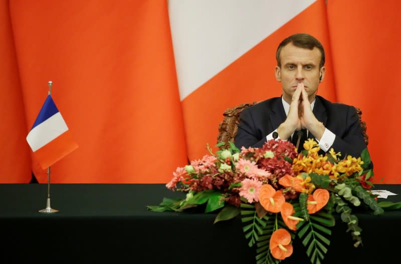 French President Emmanuel Macron attends a joint news conference with China's President Xi Jinping in Beijing