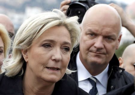 French National Front leader Marine Le Pen and presidential election candidate, walks on the Promenade des Anglais with her bodyguard Thierry Legier (R) in Nice, France February 13, 2017. REUTERS/Eric Gaillard/File Photo