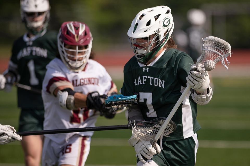 Grafton's Cam Michaud charges up the field ahead of Algonquin's Raffa Knapp during the CMADA Class A final on Tuesday May 30, 2023 in Shrewsbury.