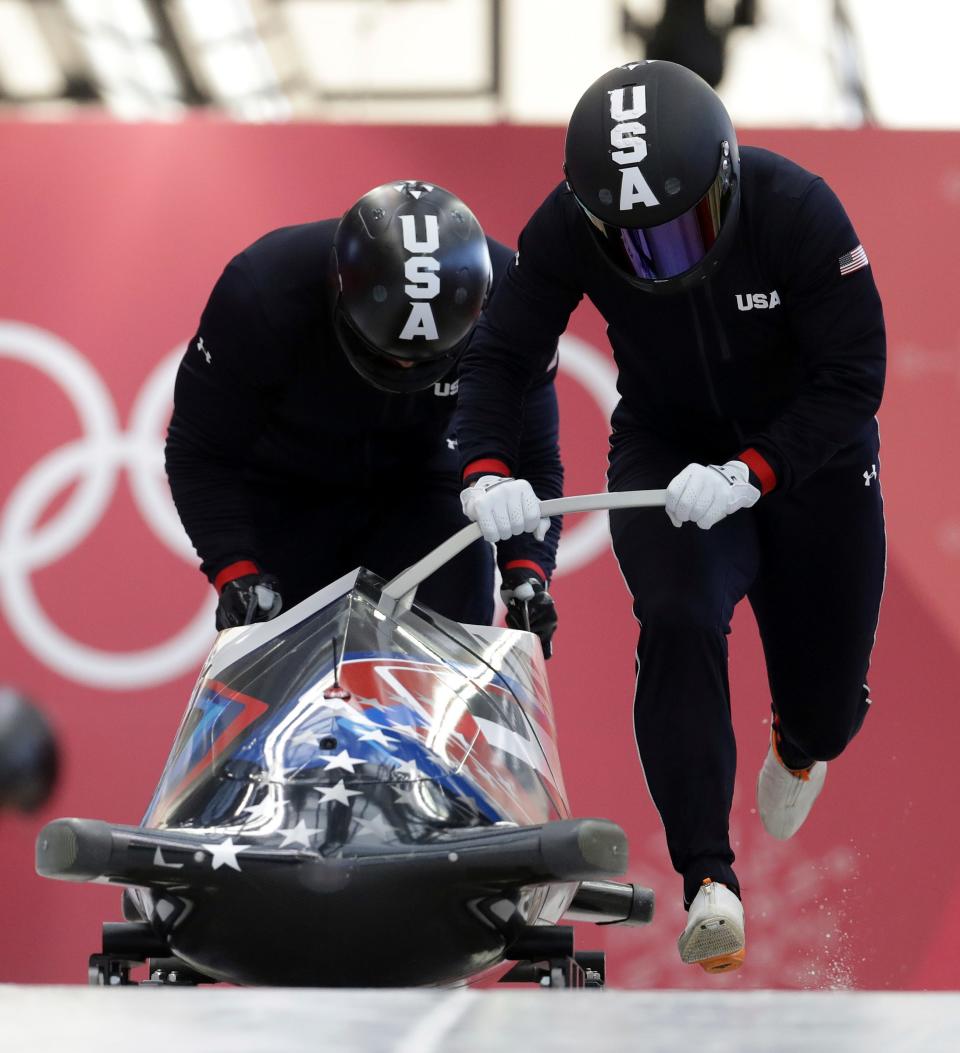 Driver Nick Cunningham and Hakeem Abdul-Saboor of the United States start a practice run during training for the two-man bobsled at the 2018 Winter Olympics in Pyeongchang, South Korea, Thursday, Feb. 15, 2018. (AP Photo/Michael Sohn)