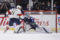 Vancouver Canucks goalie Spencer Martin, right, stops Florida Panthers' Jonathan Huberdeau during the shootout in an NHL hockey game Friday, Jan. 21, 2022, in Vancouver, British Columbia. (Darryl Dyck/The Canadian Press via AP)