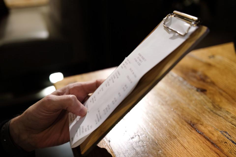 man examines calculate at restaurant