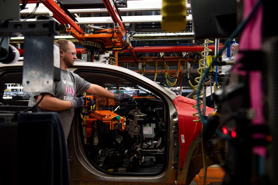 Workers install a dashboard in one of the vehicles at GM Spring Hill Manufacturing in Spring Hill , Tenn., Monday, Jan. 23, 2023.