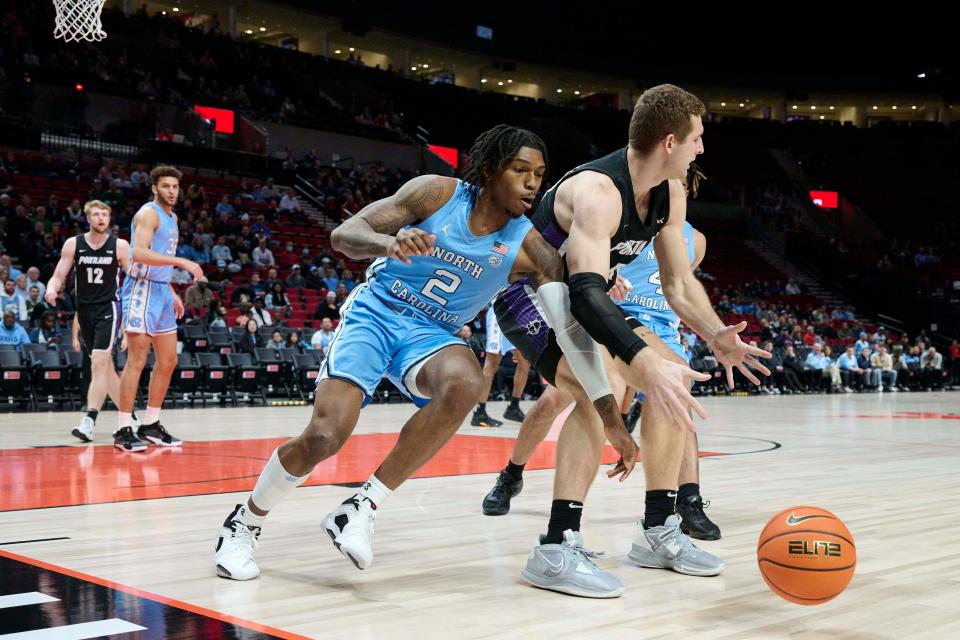 Nov 24, 2022; Portland, Oregon, USA; North Carolina Tar Heels guard Caleb Love (2) attempts to steal the basketball away from Portland Pilots center Joey St. Pierre (44) during the first half at Moda Center. Mandatory Credit: Troy Wayrynen-USA TODAY Sports