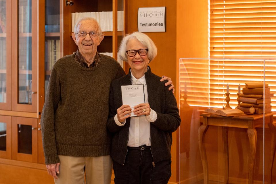 Howard and Carol Abrams pose near the Shoah Foundation Visual History archive at Central Library in Evansville, Ind., Thursday, Nov. 30, 2023. The Abrams tapped director Steven Spielberg for help in bring the testimonies to Evansville in 2005.