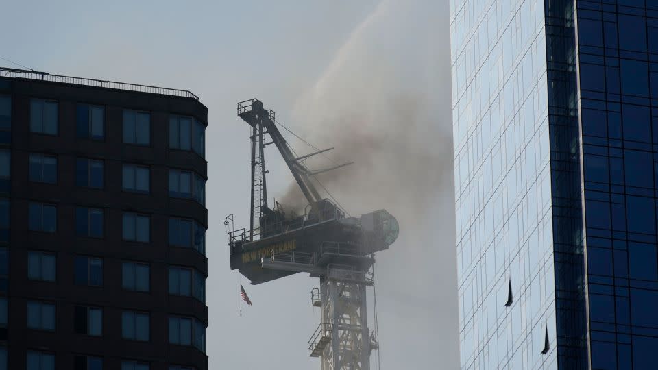 Smoke rises from a construction crane that caught fire in Manhattan on Wednesday. - Seth Wenig/AP