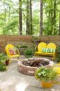 <p>Stack curved paving stones in a circle to create a statement-worthy fire pit. To make the space more inviting, scatter some metal chairs and potted plants nearby (but not too close to the fire, of course). </p><p><strong>RELATED:</strong> <a href="https://www.goodhousekeeping.com/home/gardening/g1444/fire-pit-ideas/" rel="nofollow noopener" target="_blank" data-ylk="slk:Beautiful Fire Pits to Illuminate Your Yard;elm:context_link;itc:0;sec:content-canvas" class="link ">Beautiful Fire Pits to Illuminate Your Yard </a></p>