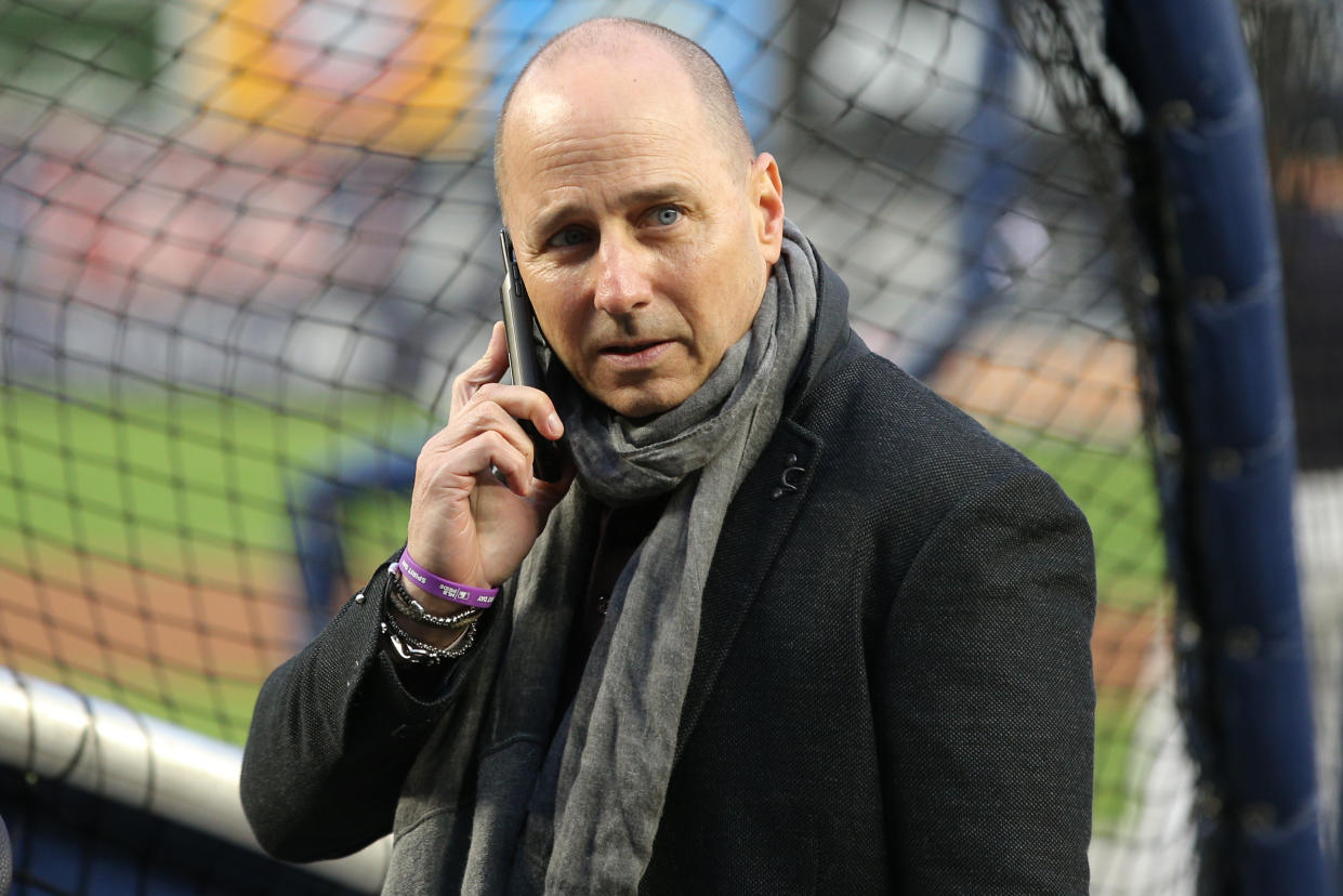 New York Yankees general manager Brian Cashman talks on his phone during batting practice before Game 4 of the 2019 ALCS series against the Houston Astros at Yankee Stadium. (USA Today)