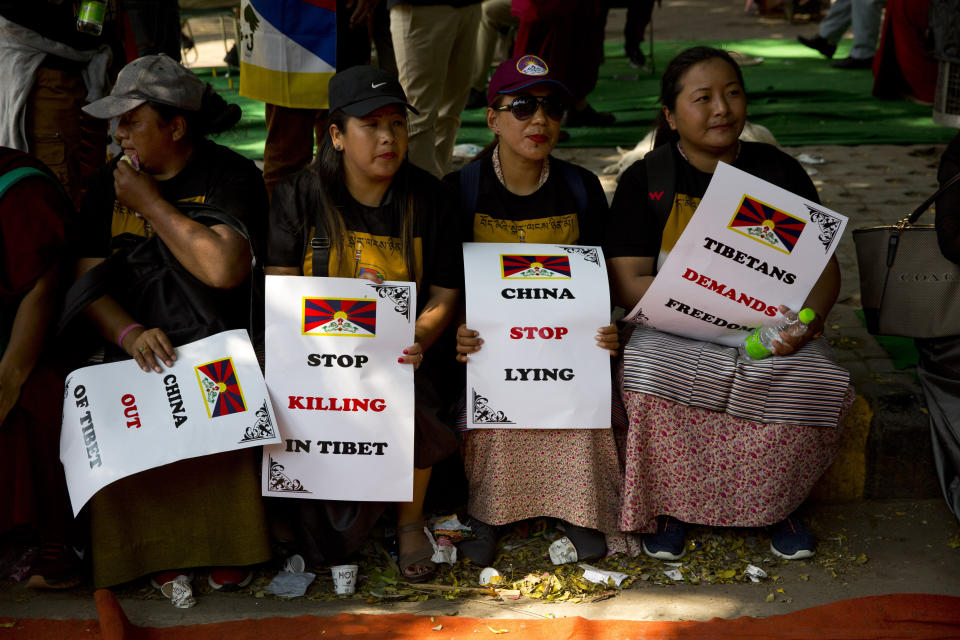 Exile Tibetan women hold banners during a rally to mark the 60th anniversary of the March 10, 1959 Tibetan Uprising Day, in New Delhi, India, Sunday, March 10, 2019. The uprising of the Tibetan people against the Chinese rule was brutally quelled by Chinese army forcing the spiritual leader the Dalai Lama and thousands of Tibetans to come into exile. Every year exile Tibetans mark this day as the National Uprising Day. (AP Photo/Manish Swarup)