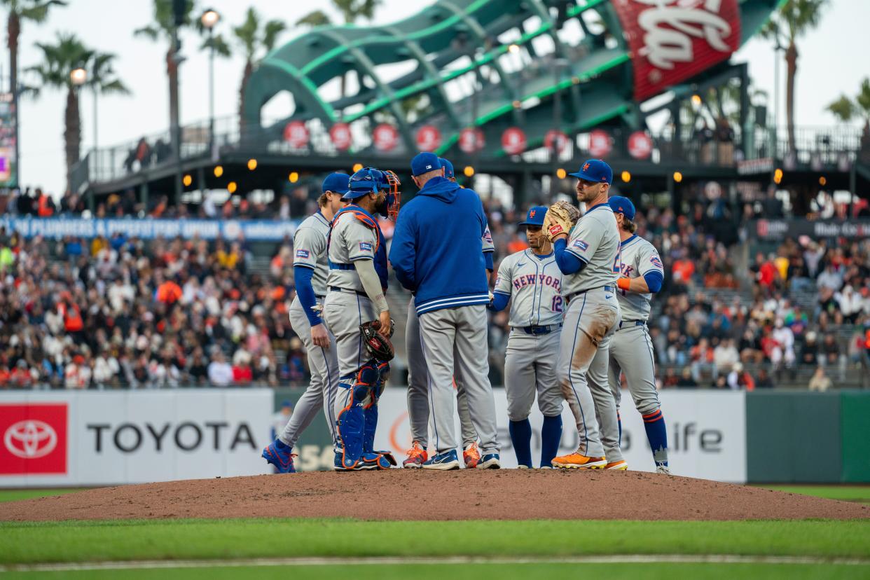 New York Mets pitching coach Jeremy Hefner (65) comes out to talk with the infield with bases loaded during the second inning against the San Francisco Giants on April 22, 2024, at Oracle Park.
