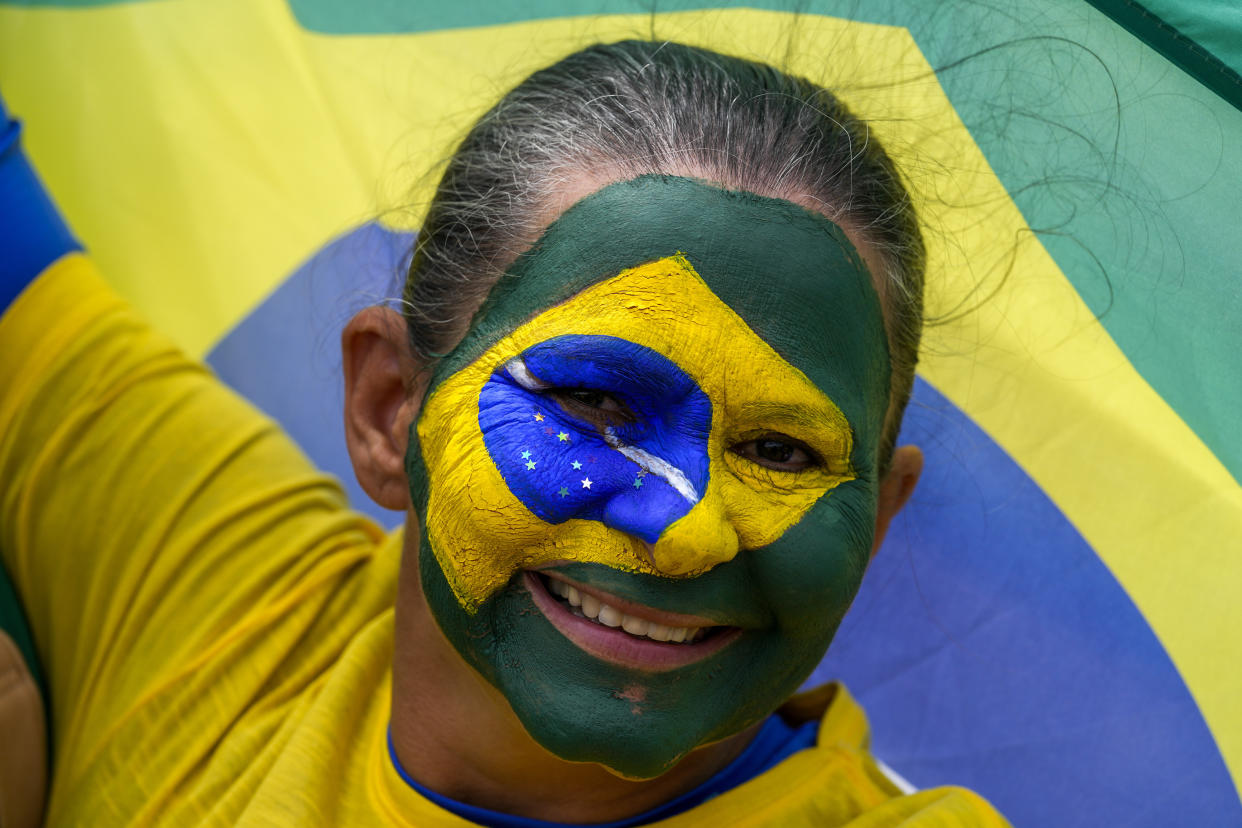 FILE - A supporter of Brazil's President Jair Bolsonaro attends a military parade commemorating the bicentennial of the country's independence, ahead of the upcoming elections, in Brasilia, Brazil, Wednesday, Sept. 7, 2022. Brazil's general elections are scheduled for Oct. 2. Incumbent Bolsonaro has shored up evangelicals support this time around with a campaign to portray the nation as spiritually ill and arguing only he can safeguard the Christian faith. (AP Photo/Eraldo Peres, File)