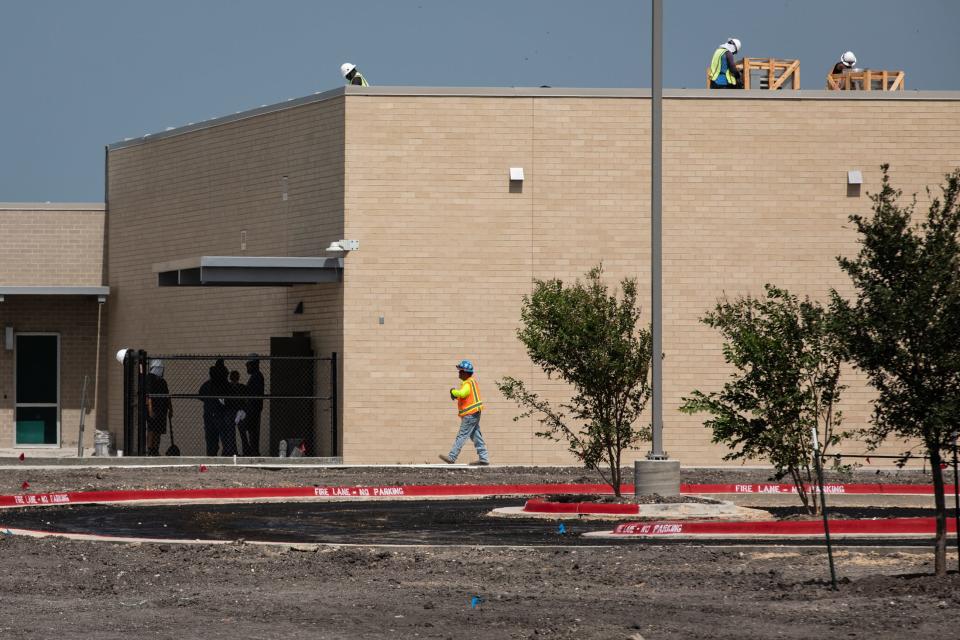 A construction crew prepares Cullen Place Elementary School for the first day of school, Tuesday, July 25, 2023, in Corpus Christi, Texas.