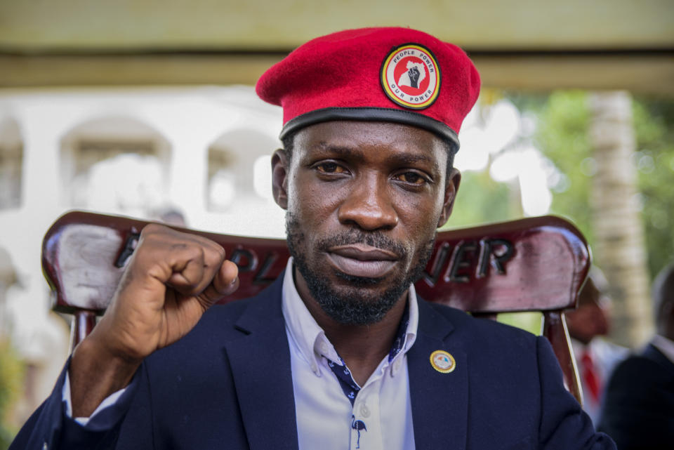 Opposition presidential challenger Bobi Wine, whose real name is Kyagulanyi Ssentamu, gestures as he speaks to the media outside his house, in Magere, near Kampala, in Uganda Tuesday, Jan. 26, 2021. An attorney for Bobi Wine says Ugandan soldiers have withdrawn from the opposition presidential challenger’s home the day after a judge ruled that his house arrest was unlawful. But the attorney tells The Associated Press that security forces can still be seen in the village near the candidate’s property outside the capital, Kampala. (AP Photo/Nicholas Bamulanzeki)