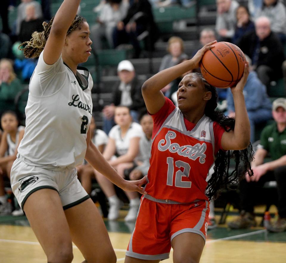 Canton South's Aniyah Hall attempts to pass around Laurel's Saniyah Hall in the first quarter of OHSAA Division II District Semifinals at Nordonia High School. Wednesday, February 28, 2024.