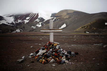 A tomb is seen at a little cemetery on Deception Island, which is the caldera of an active volcano in Antarctica, February 17, 2018. REUTERS/Alexandre Meneghini