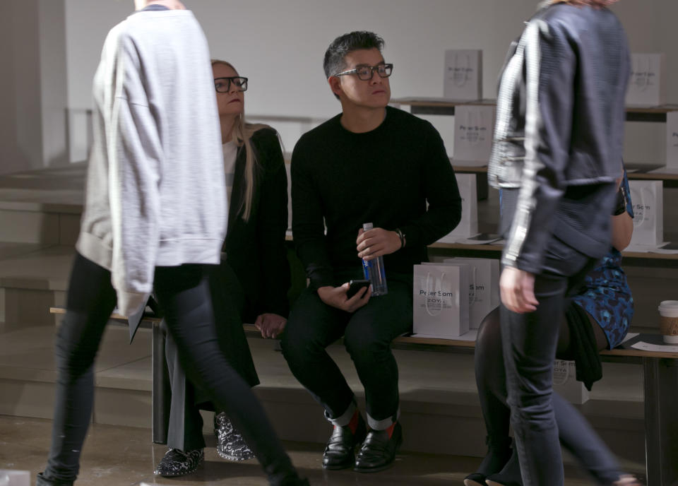 Designer Peter Som watches the rehearsal before his Fall 2014 collection is modeled during Fashion Week in New York, Friday, Feb. 7, 2014. (AP Photo/Richard Drew)