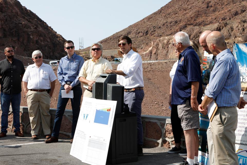 Kyle Roerink of Great Basin Water Network, center, speaks during a news conference at the Hoover Dam in the Arizona side to share demands for managing the shrinking Colorado River.