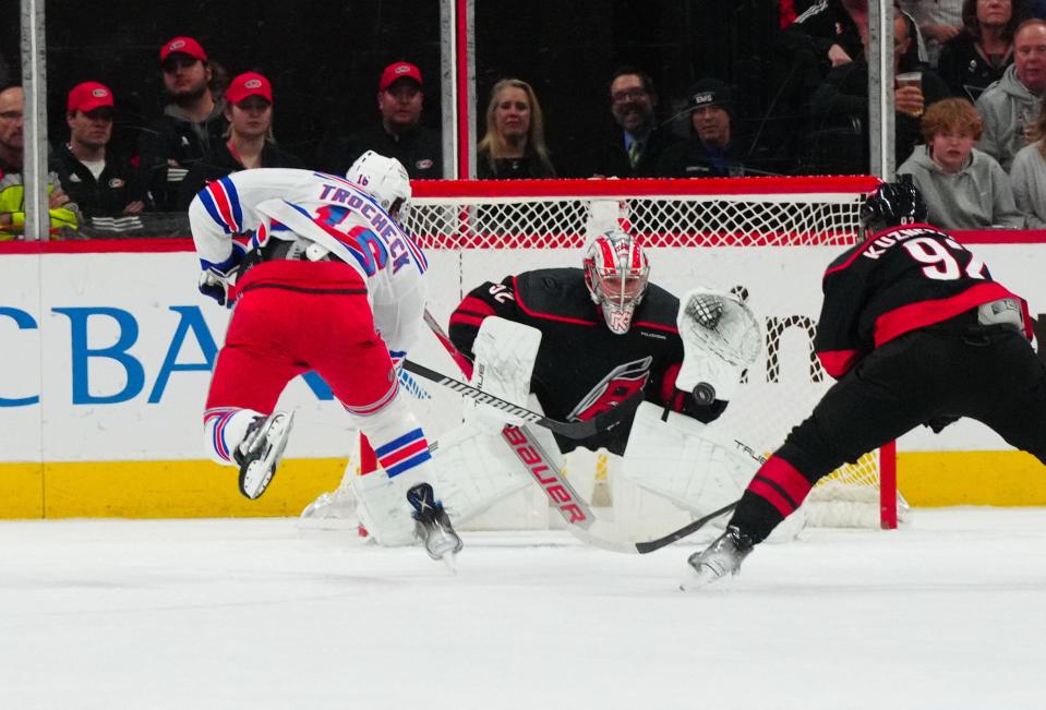 Mar 12, 2024; Raleigh, North Carolina, USA; Carolina Hurricanes goaltender Pyotr Kochetkov (52) stops the scoring attempt by New York Rangers center Vincent Trocheck (16) during the first period at PNC Arena.