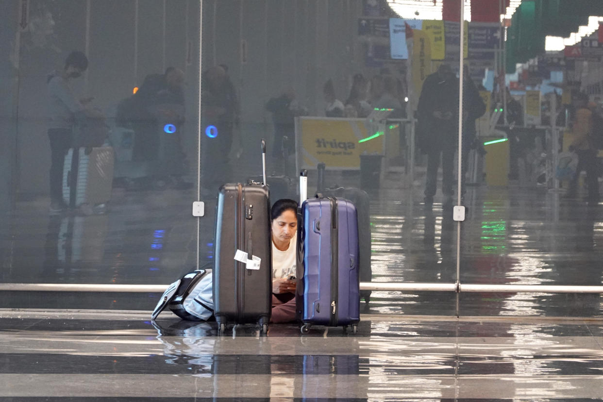 CHICAGO, ILLINOIS - DECEMBER 22: A traveler waits for a flight at O'Hare International Airport on December 22, 2022 in Chicago, Illinois. A winter weather system bringing snow, high winds, and sub-zero temperatures has wreaked havoc on holiday travel during one of the busiest days of the year for airlines. As of 8:00 AM, more than 500 flights out of Chicago had been canceled.  (Photo by Scott Olson/Getty Images)