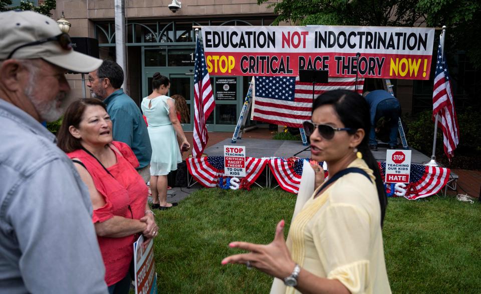 People talk before the start of a rally against "critical race theory" at the Loudoun County Government center in Leesburg, Virginia on June 12, 2021.