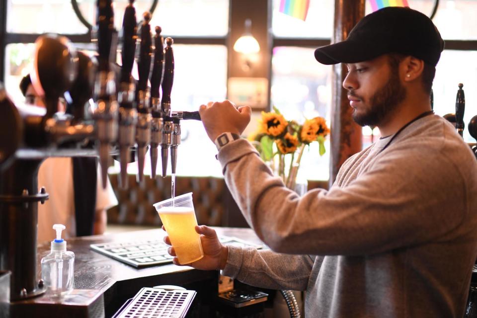 Pouring pints: takeaway pints are likely to continue, though pubs are now allowing people indoors too (AFP via Getty Images)