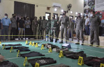 Evidence items confiscated from Ali Kalora and Jaka Ramadan, two militants who were killed during shootout with security forces, are displayed for the media during a press conference at the Parigi Moutong Police Station in Parigi Moutong district, Central Sulawesi, Indonesia, Sunday, Sept. 19, 2021. Indonesia's most wanted militant with ties to the Islamic State group was killed Saturday in a shootout with security forces, the Indonesian military said, in a sweeping counterterrorism campaign against extremists in the remote mountain jungles. (AP Photo/Mohammad Taufan)