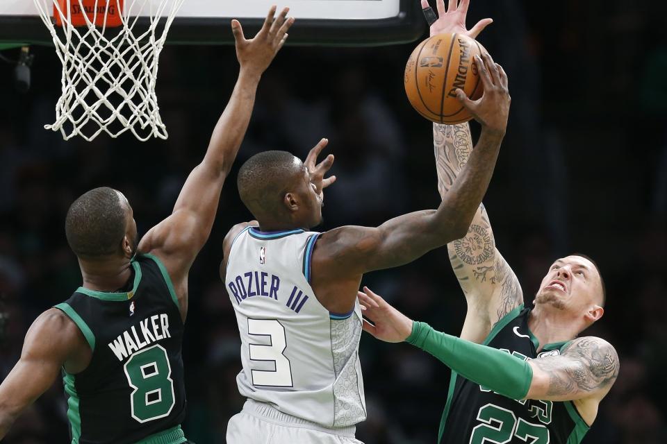 Boston Celtics' Kemba Walker (8) and Daniel Theis (27) defends against Charlotte Hornets' Terry Rozier (3) during the first half of an NBA basketball game in Boston, Sunday, Dec. 22, 2019. (AP Photo/Michael Dwyer)