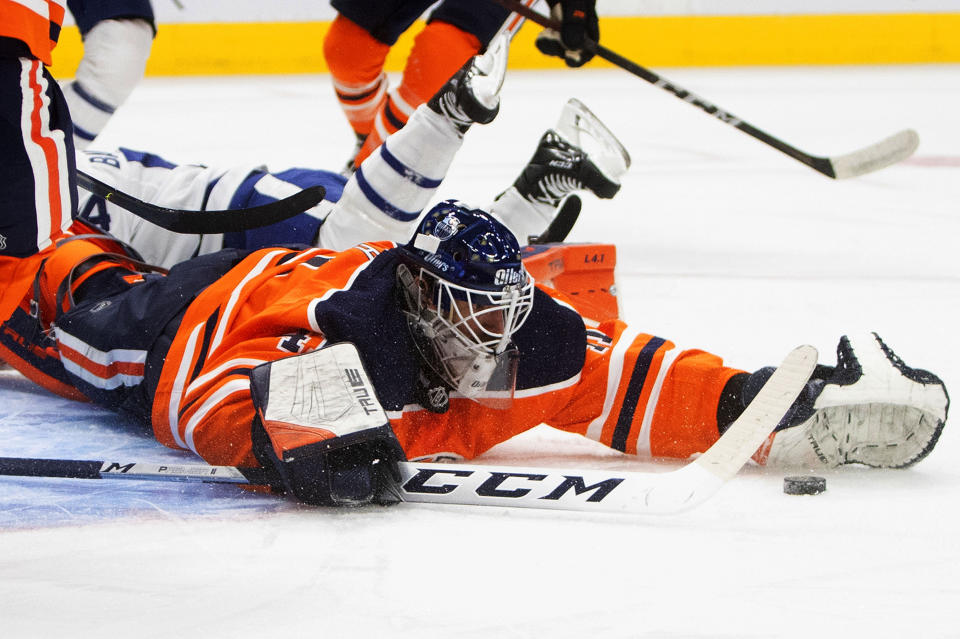 Edmonton Oilers goalie Mike Smith (41) makes the save against the Toronto Maple Leafs during the first period of an NHL game in Edmonton, Alberta, on Saturday, Feb. 27, 2021. (Jason Franson/The Canadian Press via AP)