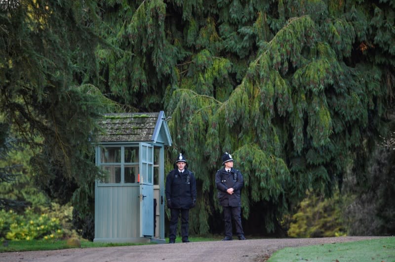 Police officers stand guard at the entrance to the Sandringham Estate in eastern England