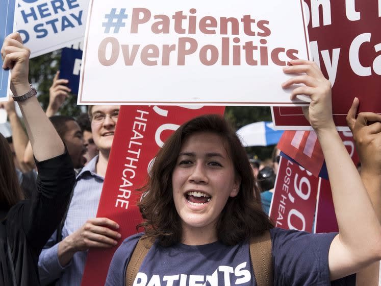 A supporter of the Affordable Care Act celebrates after the Supreme Court up held the law in the 6-3 vote at the Supreme Court in Washington June 25, 2015.  REUTERS/Joshua Roberts