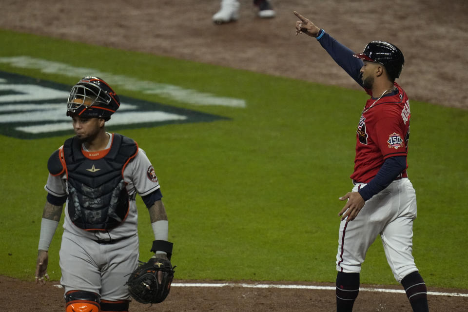 Atlanta Braves' Eddie Rosario celebrates after scoring on a double by Austin Riley during the third inning in Game 3 of baseball's World Series between the Houston Astros and the Atlanta Braves Friday, Oct. 29, 2021, in Atlanta. (AP Photo/Ashley Landis)