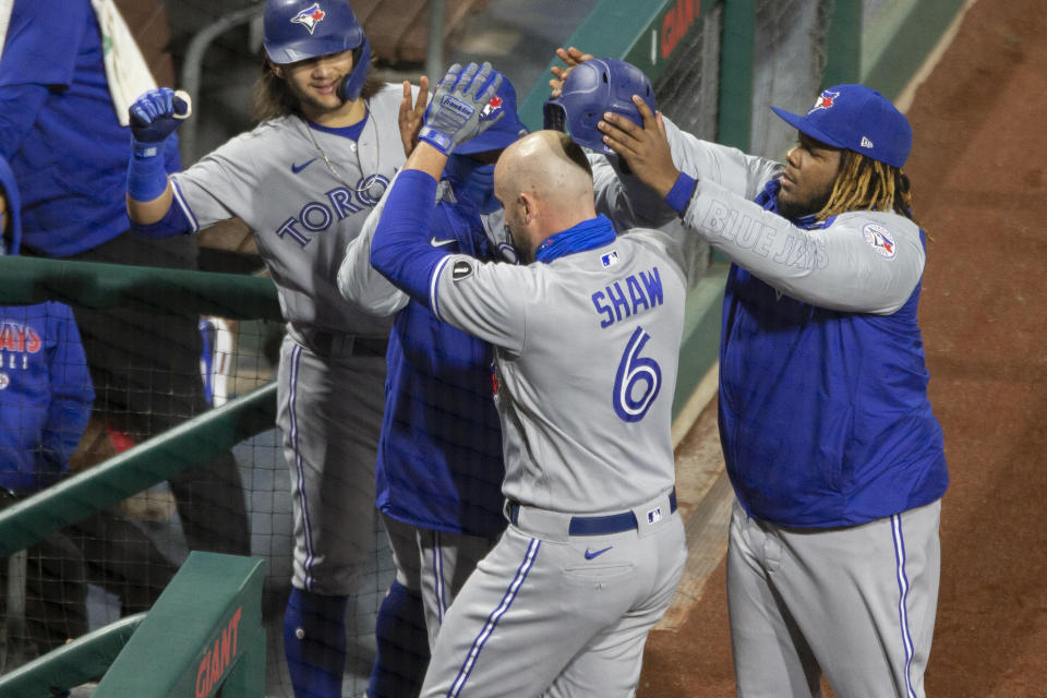 Toronto Blue Jays Travis Shaw is congratulated at the dugout after hitting a home run during the fifth inning of a baseball game against the Philadelphia Phillies, Saturday, Sept. 19, 2020, in Philadelphia. (AP Photo/Laurence Kesterson)