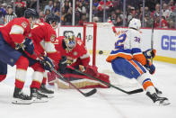 Florida Panthers goaltender Anthony Stolarz (41) makes a save as New York Islanders center Kyle MacLean (32) closes in during the first period of an NHL hockey game Thursday, March 28, 2024, in Sunrise, Fla. (AP Photo/Jim Rassol)