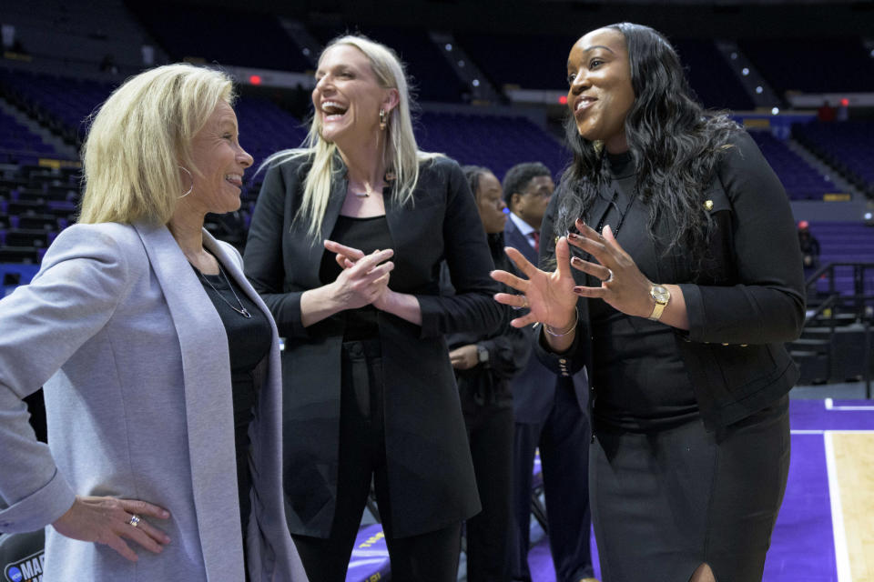 FILE - Then-Missouri State coach Amaka Agugua-Hamilton, right, talks with Florida State coach Sue Semrau, left, and then-Florida State associate head coach Brooke Wyckoff, center, before a First Four game in the NCAA women's college basketball tournament Thursday, March 17, 2022, in Baton Rouge, La. Agugua-Hamilton replaced Tina Thompson at Virginia in March after three successful years at Missouri State. Wyckoff is now head coach at Florida State. (AP Photo/Matthew Hinton, File)