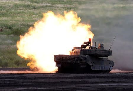 A Japanese Ground Self-Defense Force Type 10 armoured tank fires during an annual training session near Mount Fuji at Higashifuji training field in Gotemba, west of Tokyo, Japan August 25, 2016. REUTERS/Kim Kyung-Hoon/File Photo