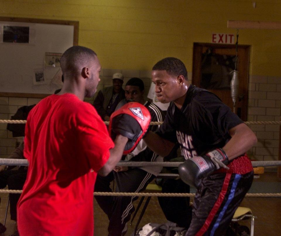Olympic hopefull Rydell Booker , right, works out in the ring with  training partner Tommy Robinson , left,  at the Cannon Recreation Center in Detroit on Feb. 2, 2000.