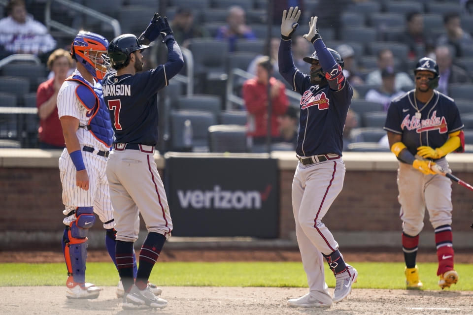 Atlanta Braves' Guillermo Heredia, right, celebrates with Dansby Swanson (7) after hitting a two-run home run off New York Mets starting pitcher Trevor Williams (29) in the eighth inning of a baseball game, Wednesday, May 4, 2022, in New York. (AP Photo/John Minchillo)
