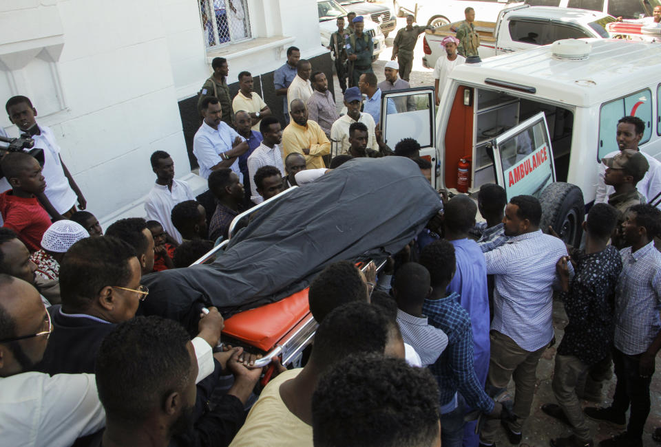 Mourners carry the body of Somali Canadian peace activist Almaas Elman to her funeral service in the capital Mogadishu, Somalia Friday, Nov. 22, 2019. Preliminary investigations show Almaas Elman was killed by a stray bullet inside a heavily defended base near the international airport earlier this week in Mogadishu, the peacekeeping mission in Somalia said Friday. (AP Photo/Farah Abdi Warsameh)