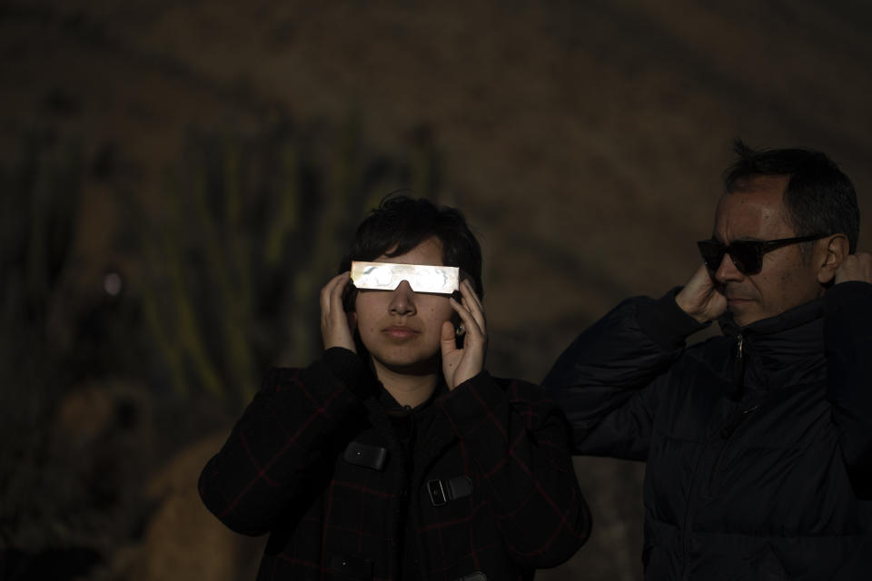 FILE - People watch a total solar eclipse in La Higuera, Chile, Tuesday, July 2, 2019. Small towns and rural enclaves along the path of April’s 2024 total solar eclipse are steeling for huge crowds of sun chasers who plan to catch a glimpse of day turning into dusk in North America. (AP Photo/Esteban Felix, File)