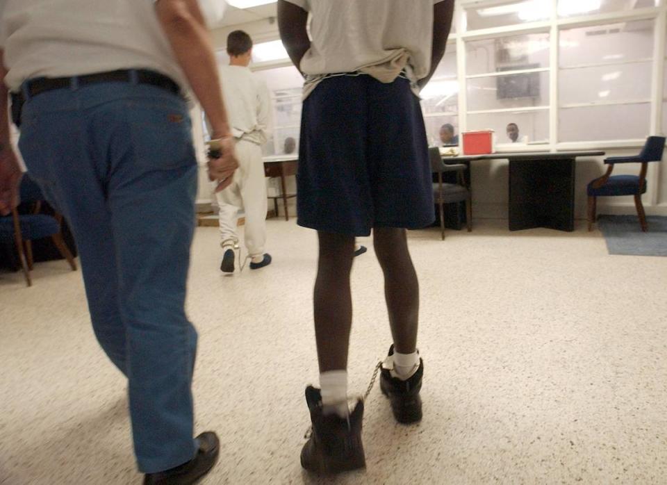 In this 2015 file photo, juveniles arrive in shackles and handcuffs at the C.A. Dillon, which is currently being used to house minors waiting for thier case to work its way through the juvenile justice system.