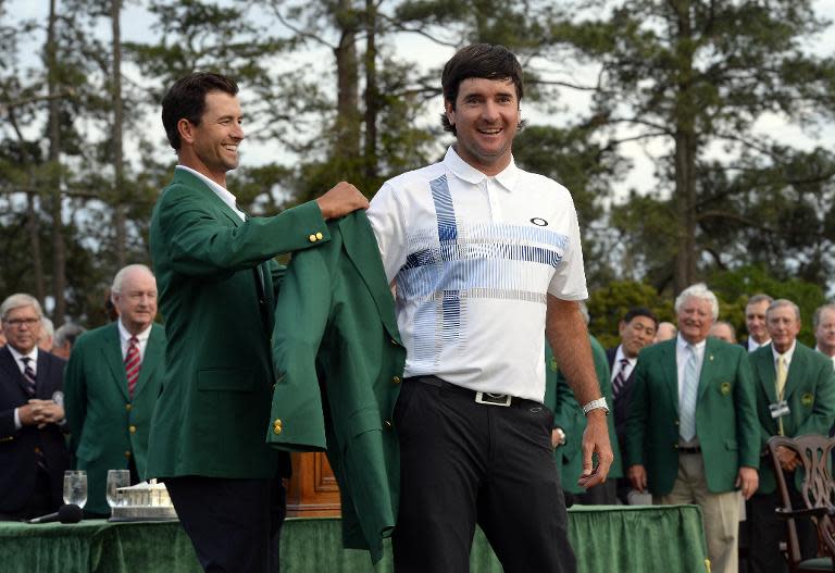 Adam Scott (L) of Australia presents Bubba Watson of the US a Green Jacket during a ceremony at the end of the 78th Masters Golf Tournament, at Augusta National Golf Club in Georgia, on April 13, 2014